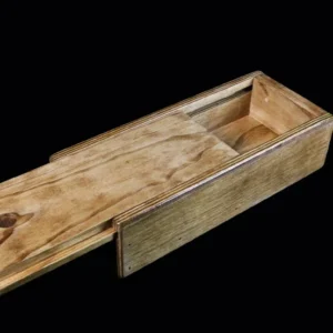 A wooden box with a sliding lid on it.