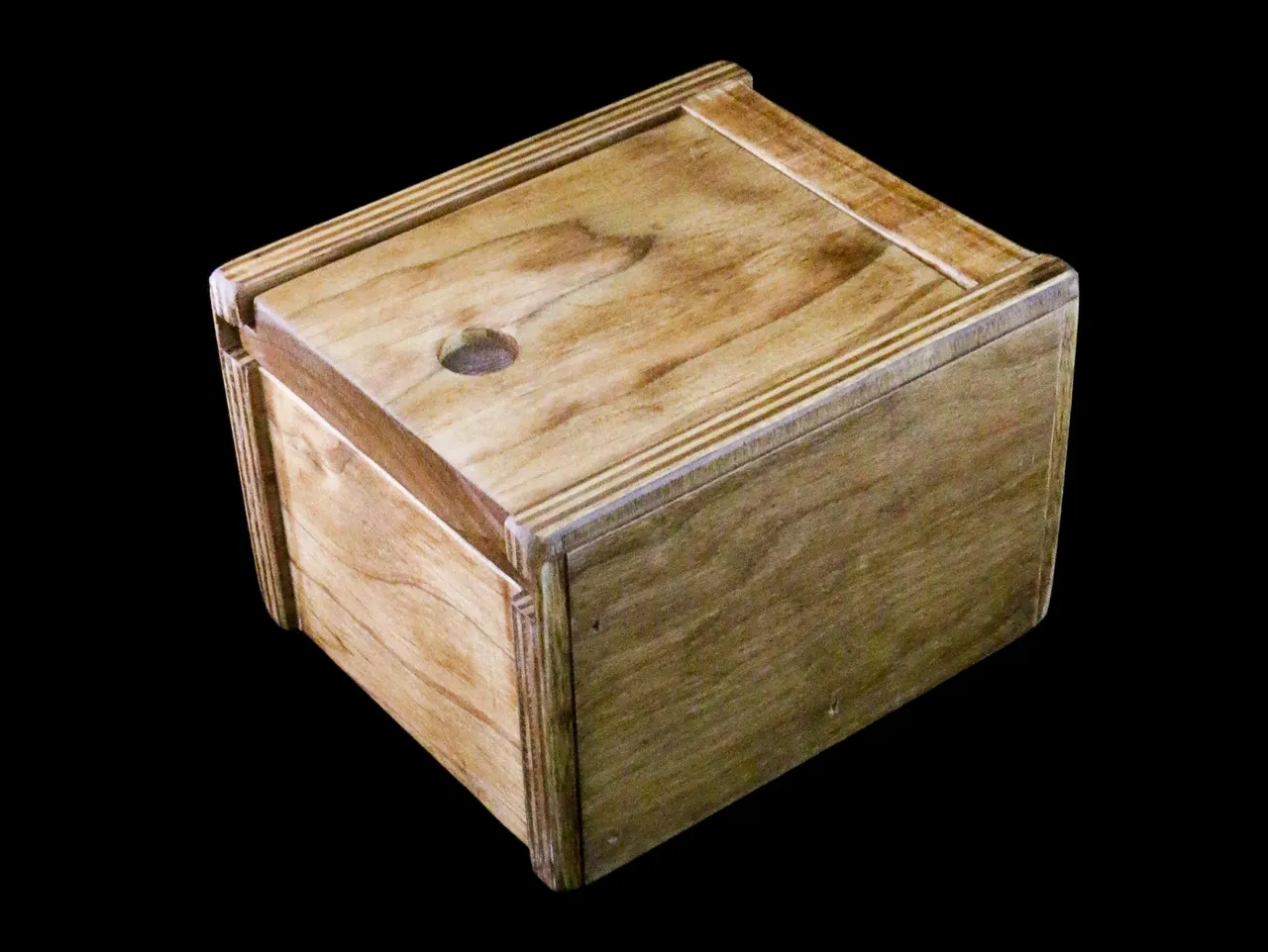 A wooden box with a lid on top of it.
