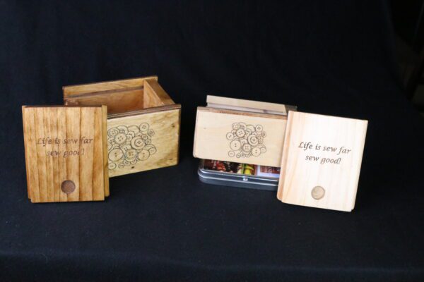 A wooden box with an open lid and a book inside.